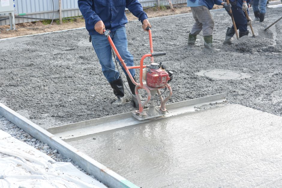 Concrete finisher smoothing a slab