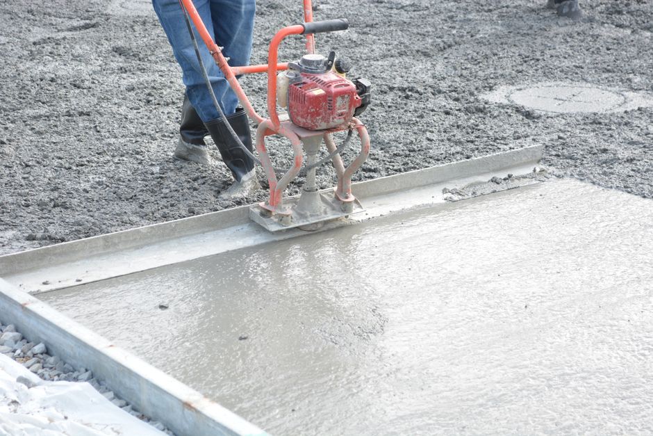 Concrete slab being poured and finished